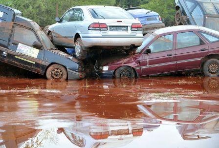 Cars are piled up in a flooded parking lot in Devecser, Hungary on October 5, 2010. (ATTILA KISBENEDEK/AFP/Getty Images)