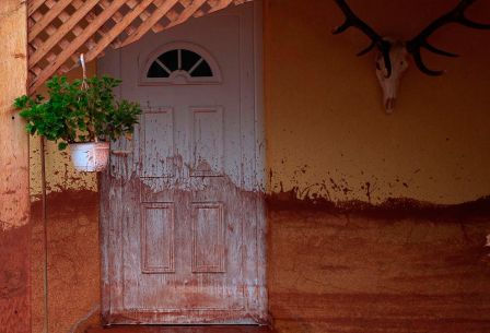 Splashed toxic sludge residue covers the walls and door of residence near Ajkai, Hungary on October 5, 2010. (REUTERS/Waltraud Holzfeind/Greenpeace)